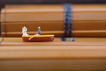 Miniature photography boating on bamboo slips