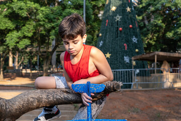 Naklejka na ściany i meble 10 year old Brazilian child playing with his Styrofoam plane on a sunny afternoon_15.
