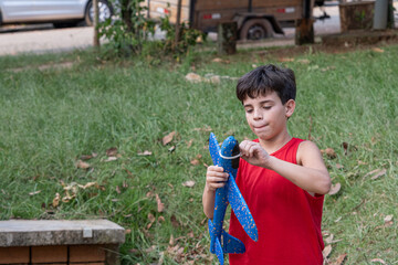 10 year old Brazilian child playing with his Styrofoam plane on a sunny afternoon_18.