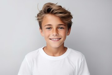 Close-up portrait of a smiling little boy in a white t-shirt. - Powered by Adobe