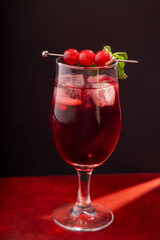 glass of red wine cocktail with berries