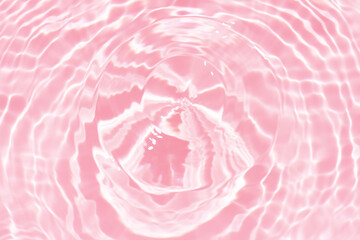 Pink water background. Pink water splashes on the surface ripple blur. Defocus blurred transparent...