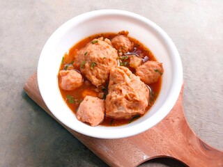 bakso, meatballs, traditional Indonesian food. Meatball soup. meatballs stuffed with quail eggs without noodles or vermicelli served in a bowl on a gray background.
