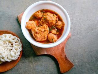 bakso, meatballs, traditional Indonesian food. Meatball soup with crackers. meatballs stuffed with quail eggs without noodles or vermicelli served in a bowl on a gray background.