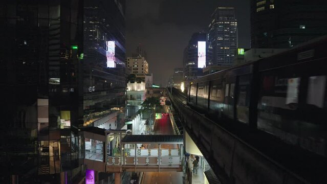 Urban transportation of Bangkok, Thailand in Chit Lom area. Sukhumvit main road, sky bridge pedestrian and sky train in one place. And Central World Mall as a background
