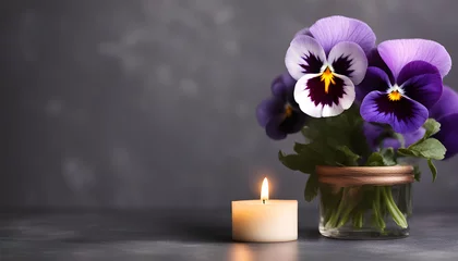 Poster Beautiful purple pansy flower and burning candle on dark background © Mr Ali