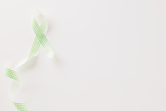 Green awareness ribbon symbol of Gallbladder and Bile Duct Cancer month isolated on white background with copy space, concept of medical and health care support, Cancer awareness, World bipolar day