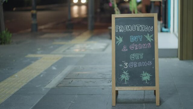 Signage for cannabis dispensaries and marijuana shops on street corners in Bangkok, Thailand