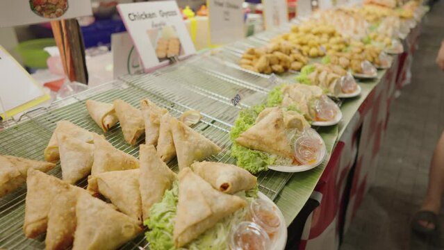 Street food vendors in MBK Plaza, Bangkok, Thailand . They sell fried chicken, samosa, gyoza, cheese ball, fried shrimp
