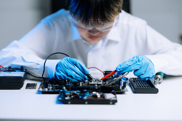 The technician is putting the CPU on the socket of the computer motherboard. electronic engineering...