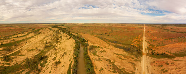 Aerial view of a treelined waterhole in the Australian outback