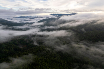 Top view Landscape of Morning Mist with Mountain Layer at north of Thailand. mountain ridge and clouds in rural jungle bush forest