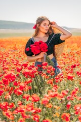 Obraz na płótnie Canvas Woman poppies field. portrait happy woman with long hair in a poppy field and enjoying the beauty of nature in a warm summer day.