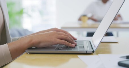 Business person, hands and typing on laptop for email, communication or research at office desk. Closeup of employee working on computer for proposal, social media or online networking at workplace