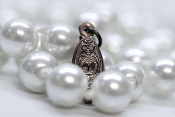 Antique pendent in the middle of pearls chain.