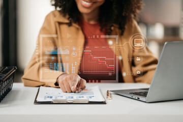 Female writes information businessman working on laptop computer writing business plan while sitting in office.