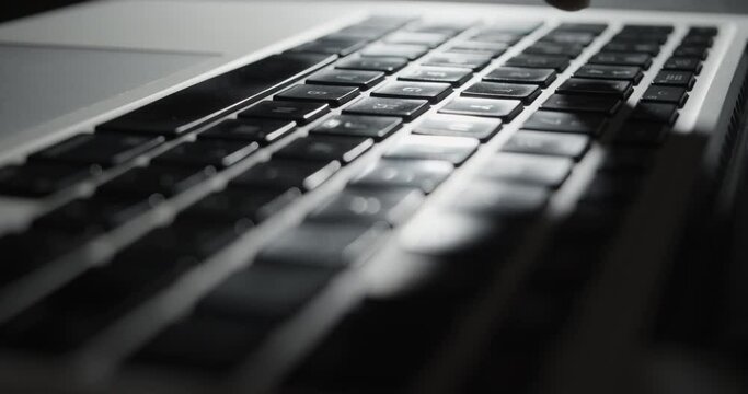 Finger Typing on Laptop Keyboard with Long Shadows