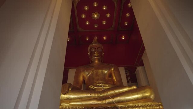The Big golden or bronze Buddha image in Wihan Phra Mongkhon Bophit, in ancient capital of Ayutthaya Thailand