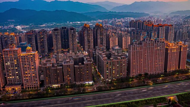 drone hyperlapse, time-lapse, aerial view, san-xia apartment complex highway heavy traffic, dusk time evening sunset time orbit turn, sunset landscape behind it.Taiwan,Asia,
