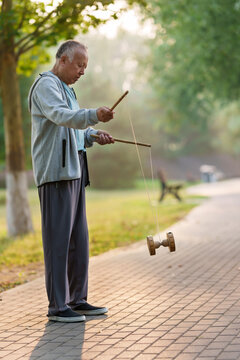 Old people shaking diabolo in the park