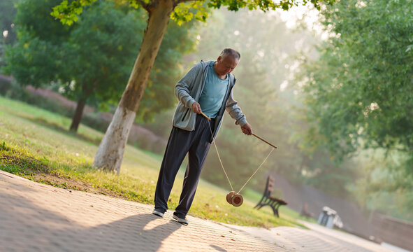 Old people shaking diabolo in the park