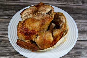 Arabic cuisine of machine grilled barbecued chicken, a whole chicken barbecued in a chicken grill...