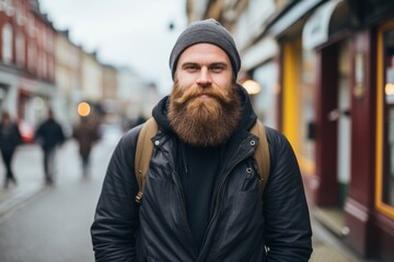 Handsome bearded hipster man with long beard and mustache in the city