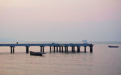Fototapeta na wymiar Small boat mooring at jetty with twilight sky