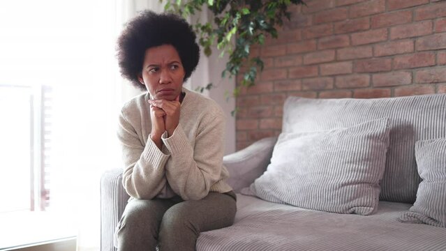 Depressed woman sitting at home in solitude