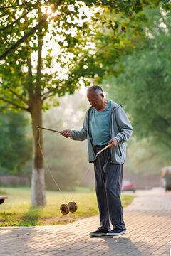 Old people shaking diabolo in the park