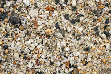 Small loose, different shape and size stones background. Textured, close up.