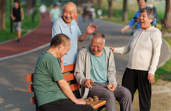 Old people in the park play chess