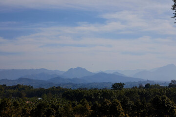 Scenic view of mountains against sky and tropical forest