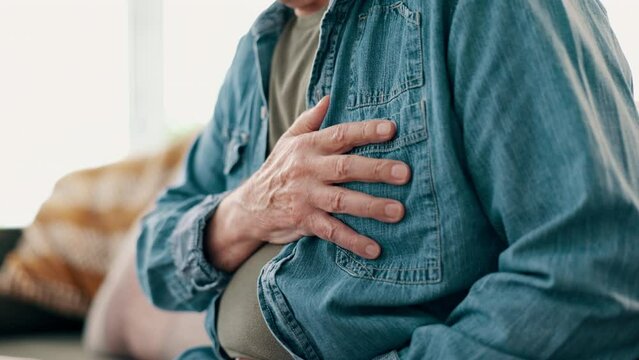 Home, old man and heart attack with hands, chest pain and closeup with retirement and sick. Pensioner, apartment and elderly guy with cardiac arrest or asthma with injury, hurt and ill with emergency