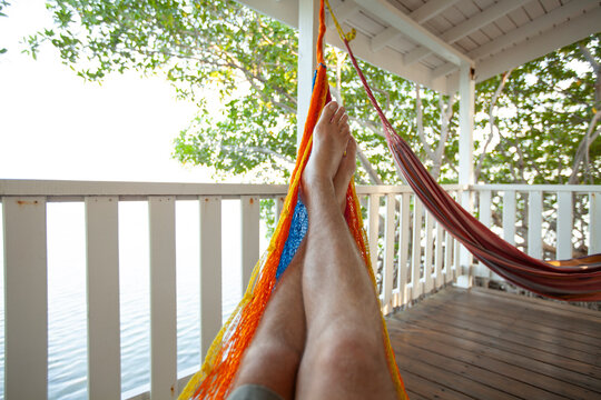 Belize island South Water Caye. Guy lying in a hammock