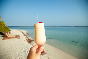 Belize island South Water Caye. Fruity cocktail on the beach