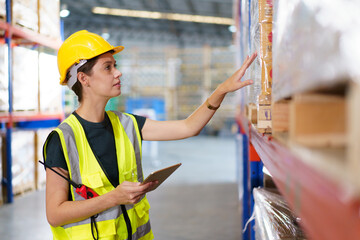 The female warehouse officer is currently inspecting the stock of goods in the warehouse.