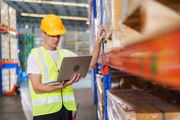 Caucasian male warehouse officer is currently conducting a stock inventory inside the warehouse. 