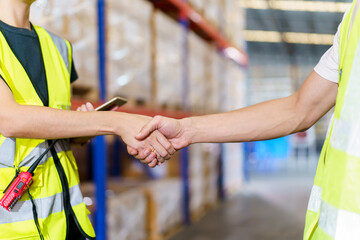 Caucasian male and female warehouse personnel engage in amicable conversation, culminating in a...