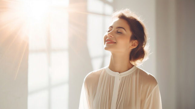 Joyful woman basking in the natural sunlight indoors, with a serene and content expression.
