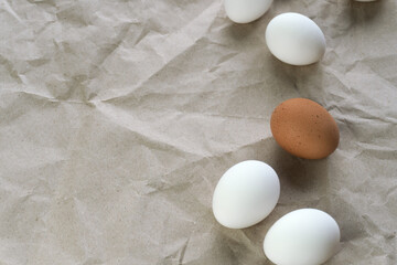 White and brown eggs on the table. View from above