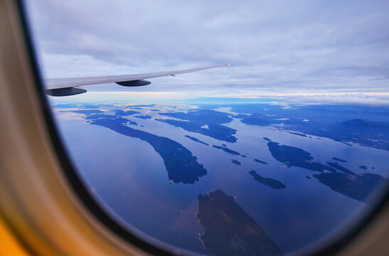 View from airplane window on fields in wing with top view of Vancouver,Canada