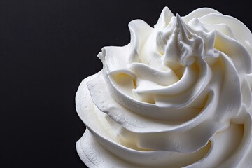 Whipped cream or meringue against black background
