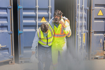 Male rescue workers PPE uniforms wearing gas mask protect against accidental leaks toxic fumes dangerous gases pungent odor keep workers unconscious safe from dangerous toxins inside container.