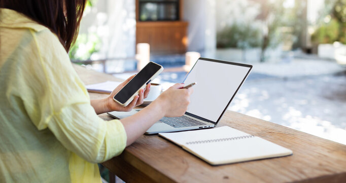 Young Asian Woman Using Computer Laptop And Smart Phone Working In A Cafe And Drinking Coffee, Young Asian Girl Student With Computer Study Online In The Summer