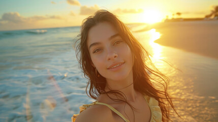 Fototapeta na wymiar Young Woman Enjoying Sunset on the Beach