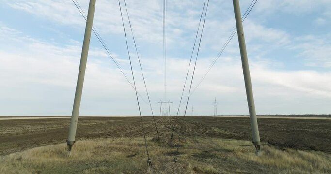 Power Lines and High Voltage Electricity Transmission Pylon.Power Lines Supply With Wire. Aerial drone view High Voltage Electric Tower With Insulators. Electricity Transportation Industry Energetics