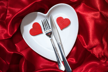 Heart plate with silverware of fork and knife with a red heart
