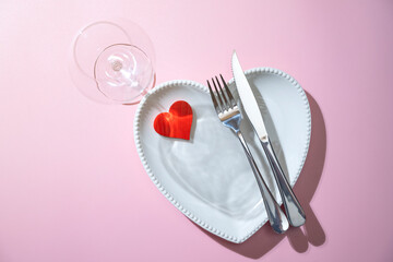Heart plate with silverware of fork and knife with a red heart