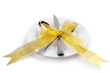 Fototapeta premium White plate with silverware of fork, knife, and spoon tied up on ribbon